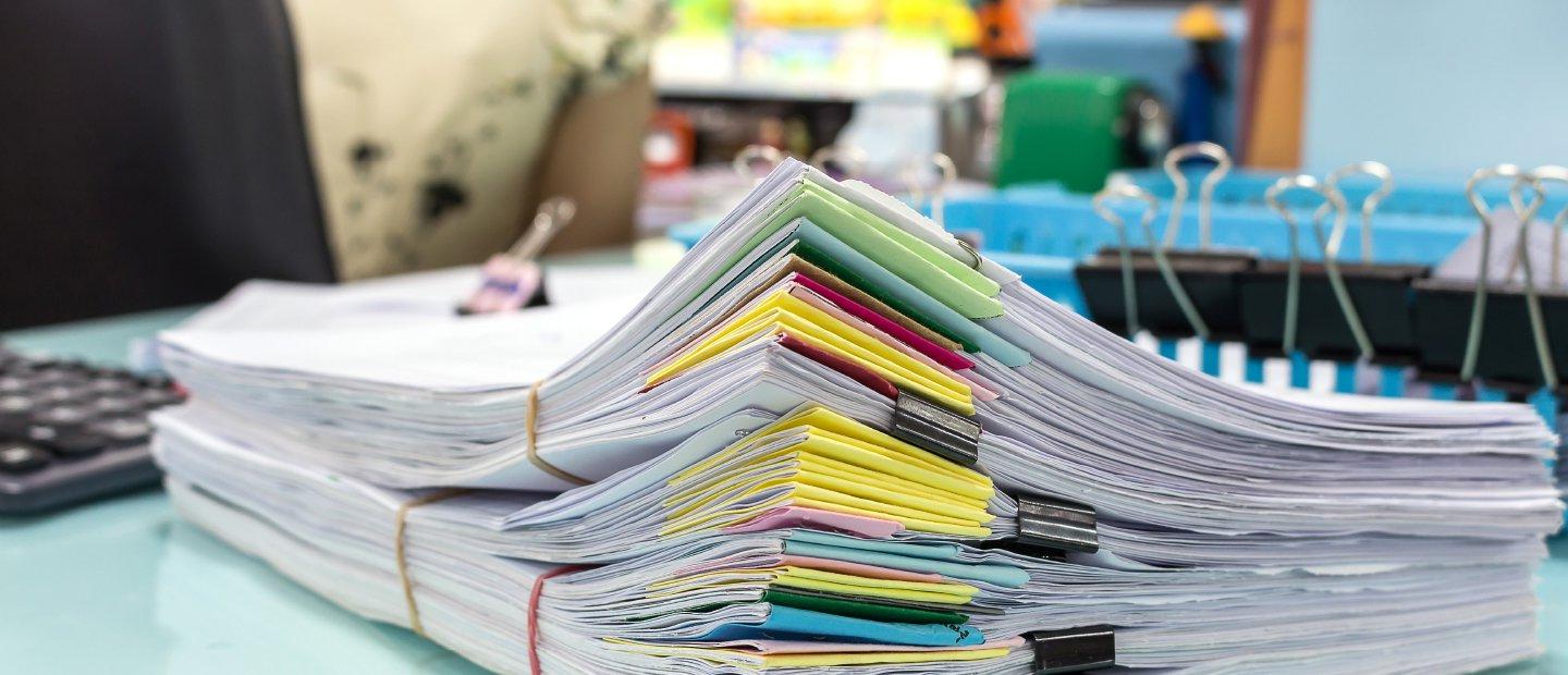 Piles of paper with colorful page markers